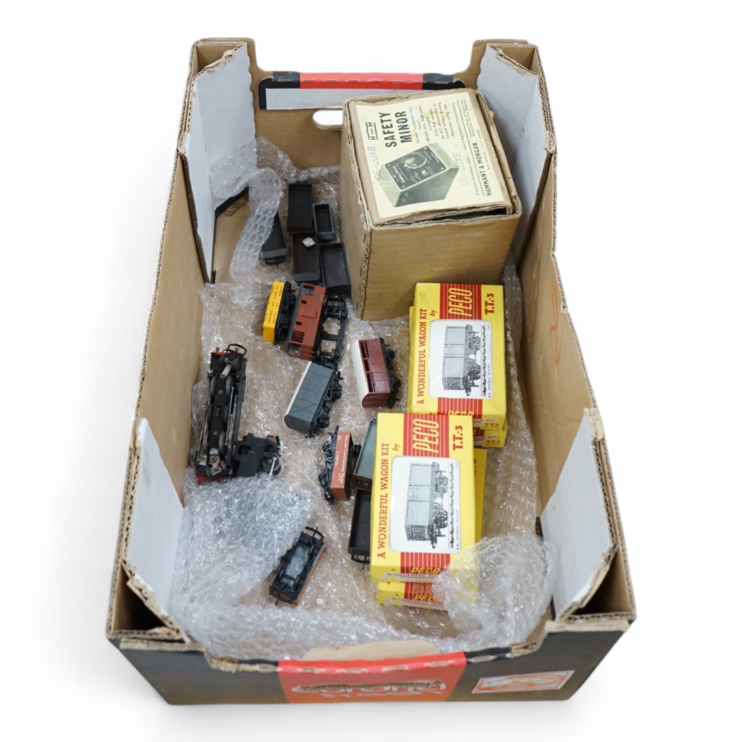 Fifteen items of TT gauge model railway by Peco, etc. including two white metal kit-built locomotives; a BR Prairie tank and a GWR 0-6-0T, together with 13 mainly kit built freight wagons, etc. Condition - fair, some rep